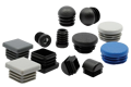 A selection of plastic tube inserts. Square, round, threaded and domed. In black, grey, white and blue.